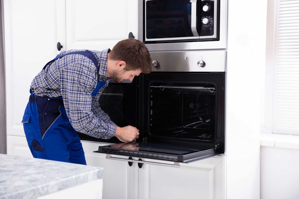 a technician repairing an oven