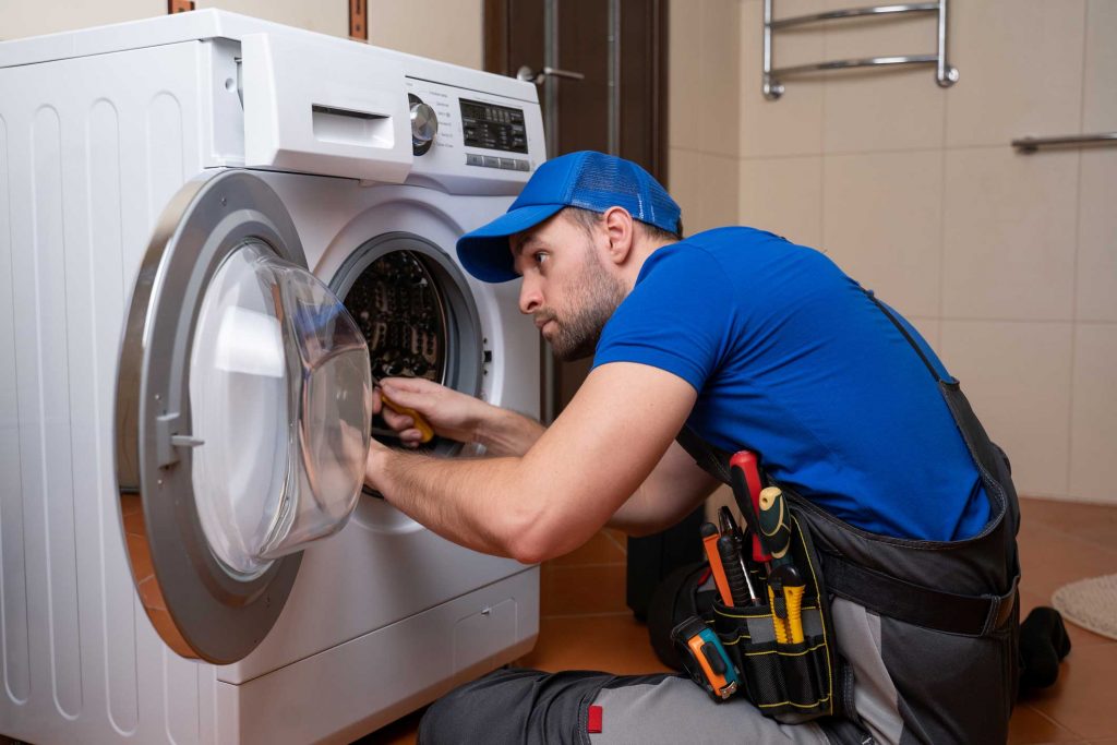 a technician repairing a washer and dryer repair brooklyn